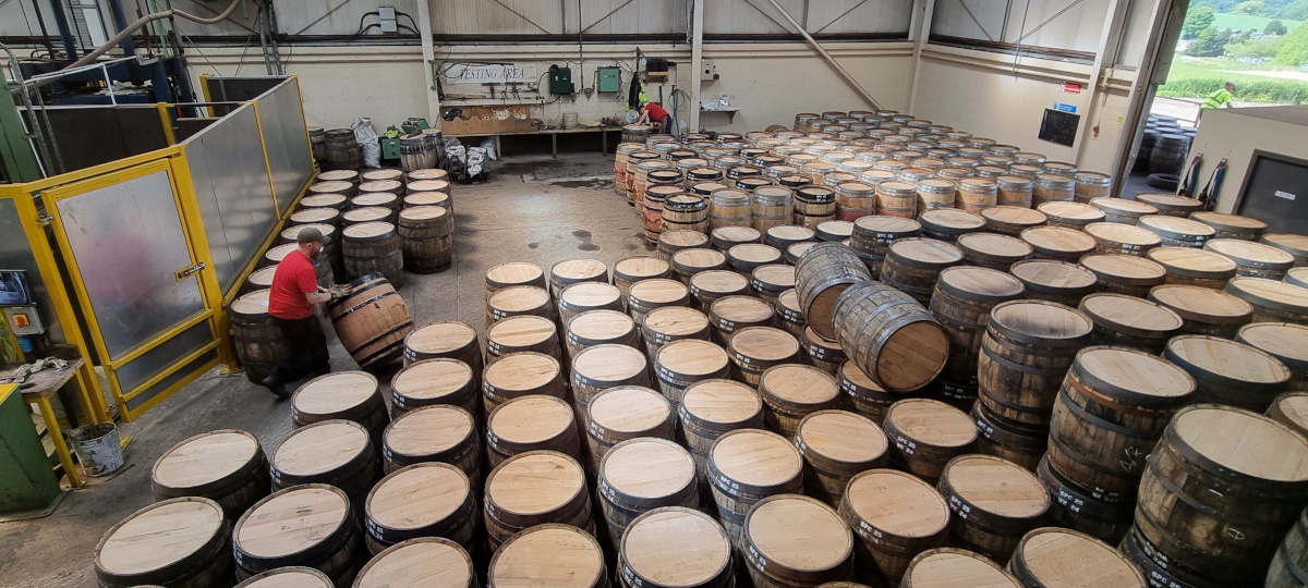 A view from above the shop floor at Speyside Cooperage. Rows of completed barrels are visible, ready to be pressure tested.
