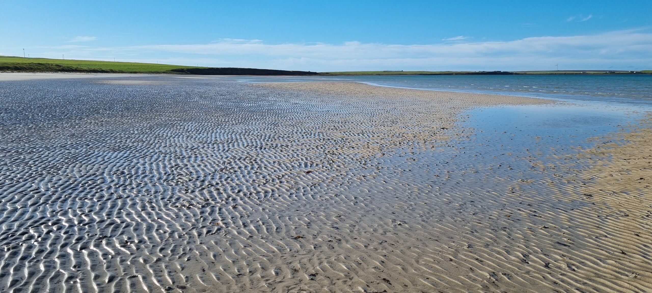 A beach on Stronsay A very flat beach on Stronsay with the tide way out and thousands of ripples in the sand on a fine sunny day.