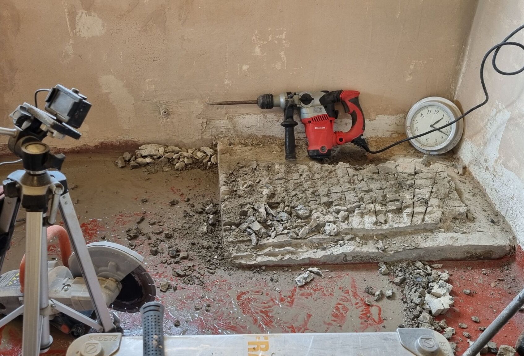 concrete-removal a hammer drill and disc cutter start to work away at the concrete base.