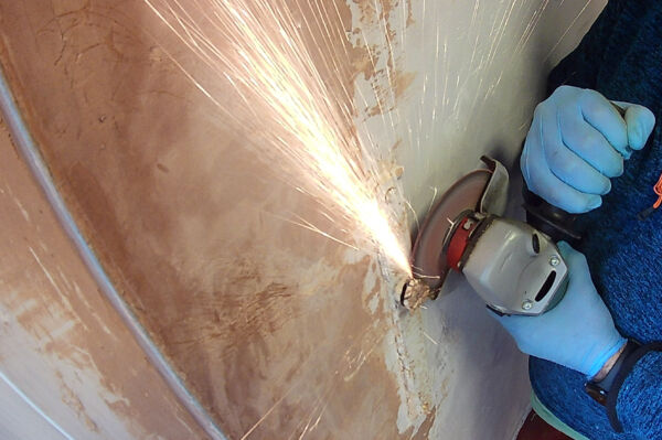angle grinder Sparks flying from an angle grinder removing a metal rod sticking out of a wall in the brewery