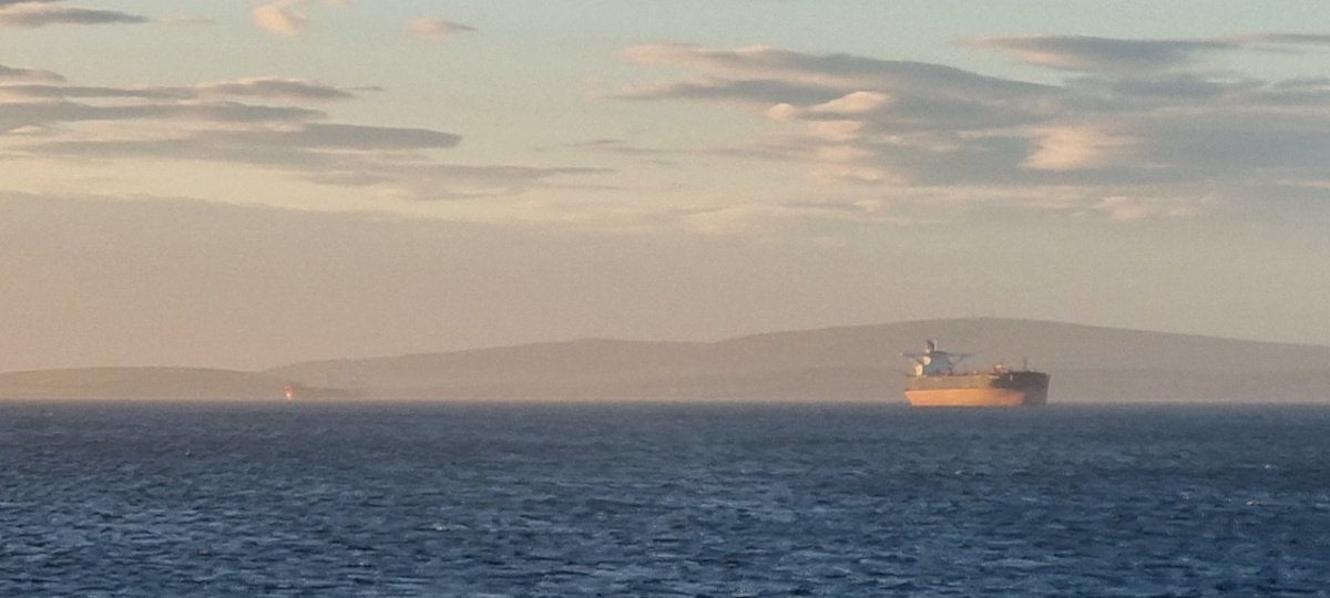 Tankers moored in Scapa Flow Orkney at sunset.