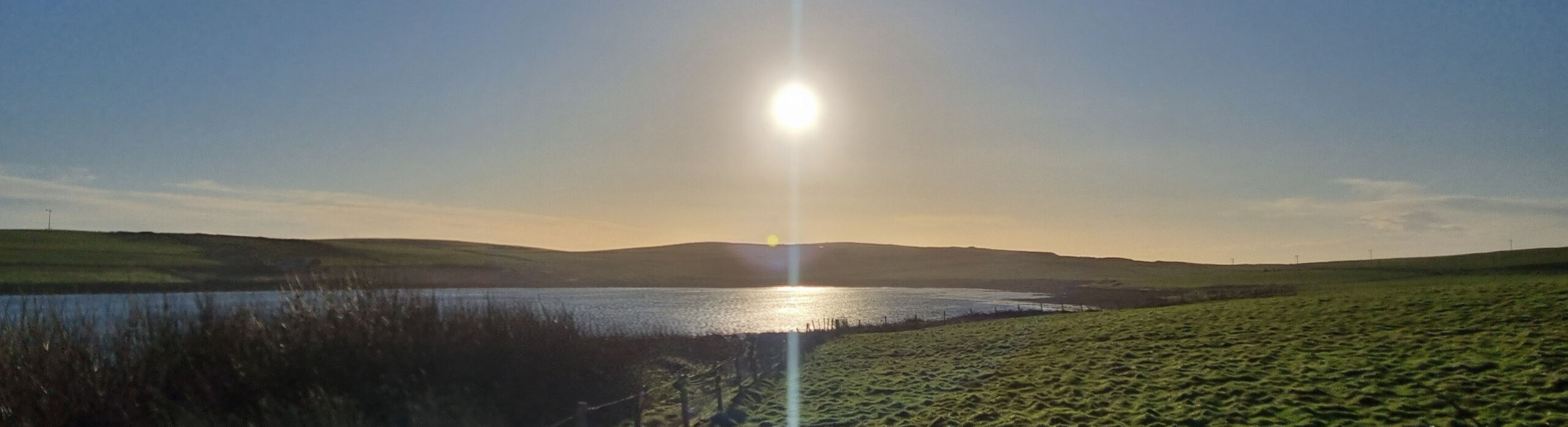The sun hangs low in the sky at midday in Orkney at the winter solstice.